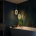 Perla textured LED pendant light on a gold cord