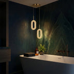 Perla textured LED pendant light on a gold cord